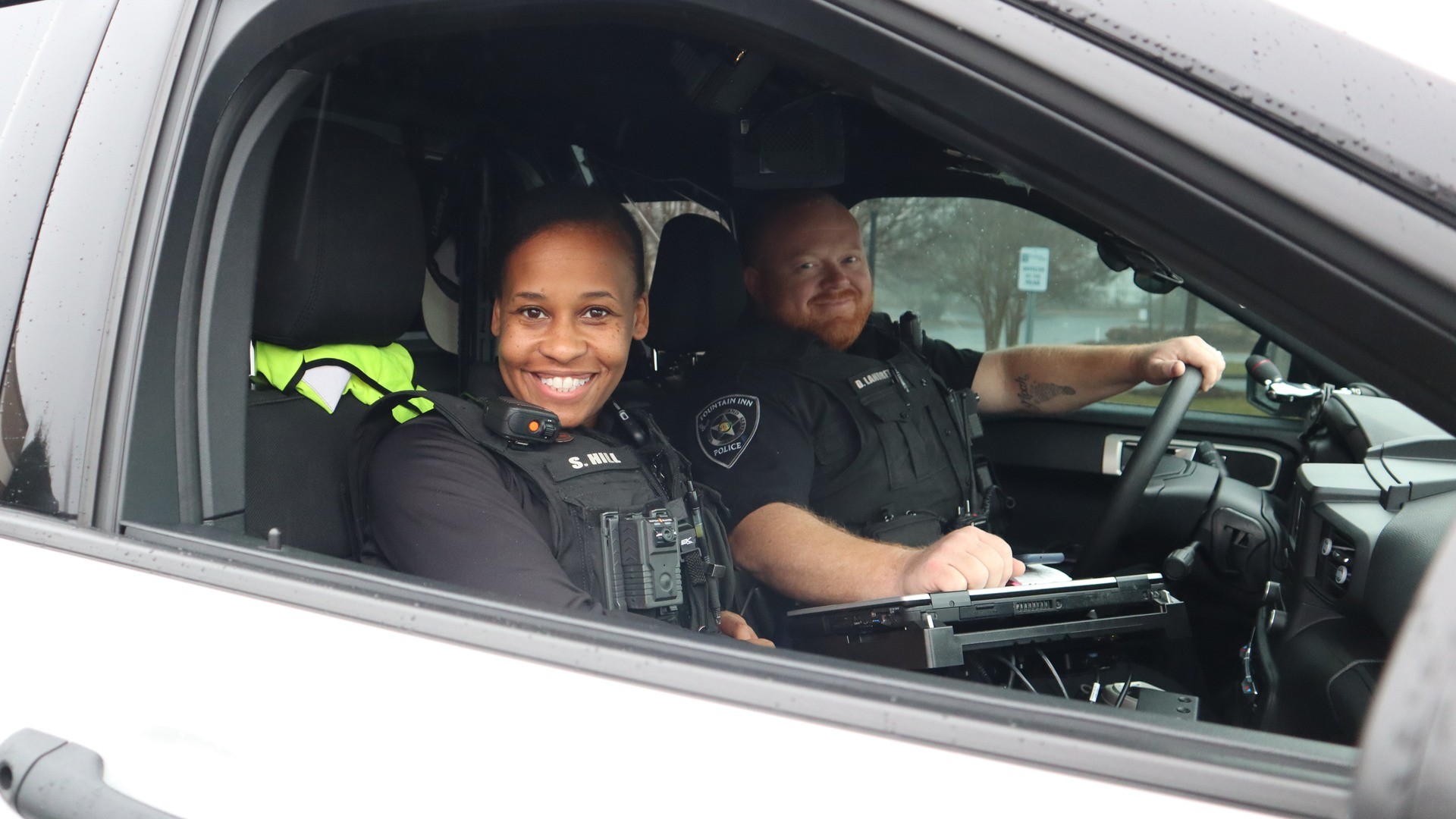 male and female officer in patrol car