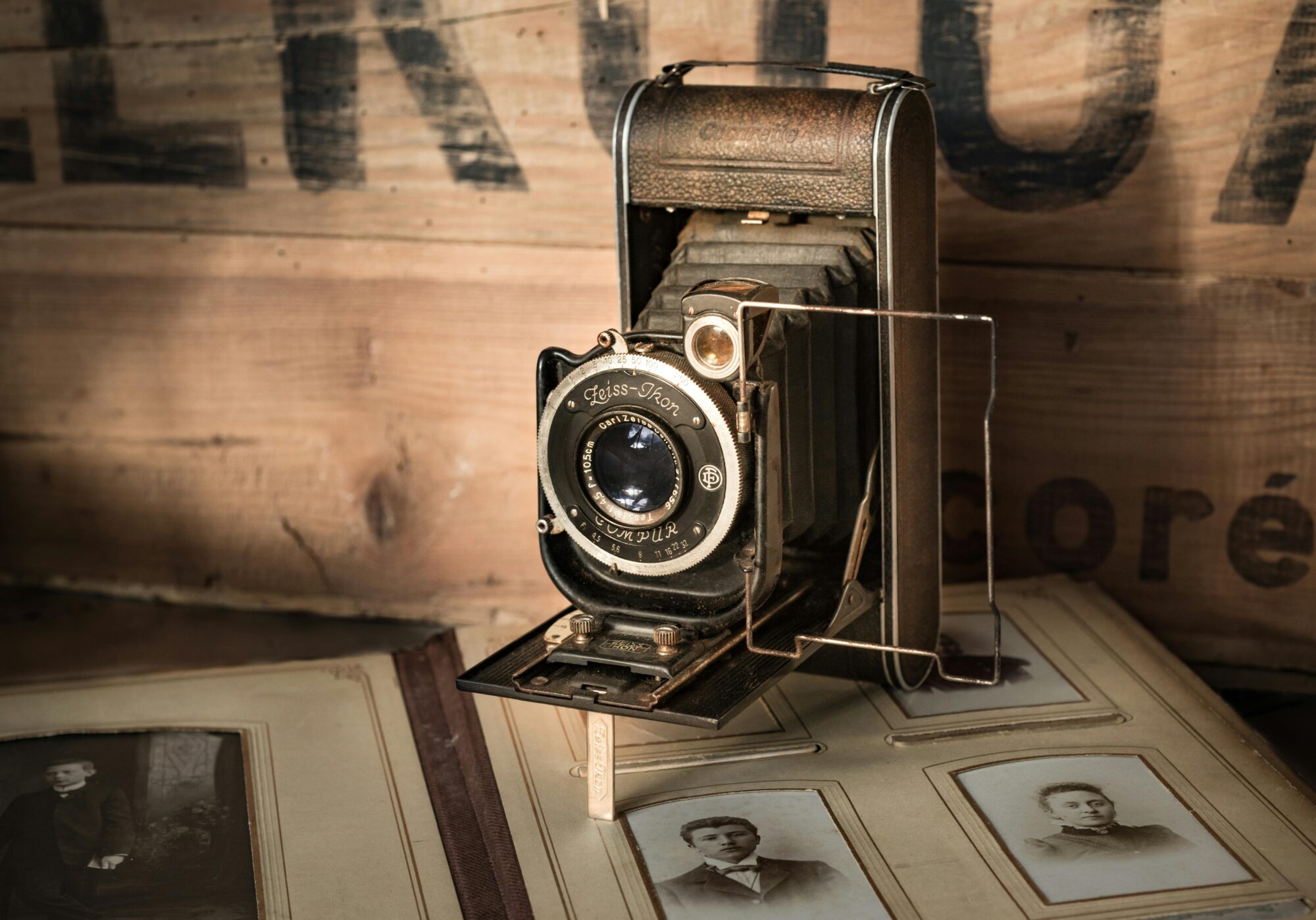 antique camera on open antique photo album